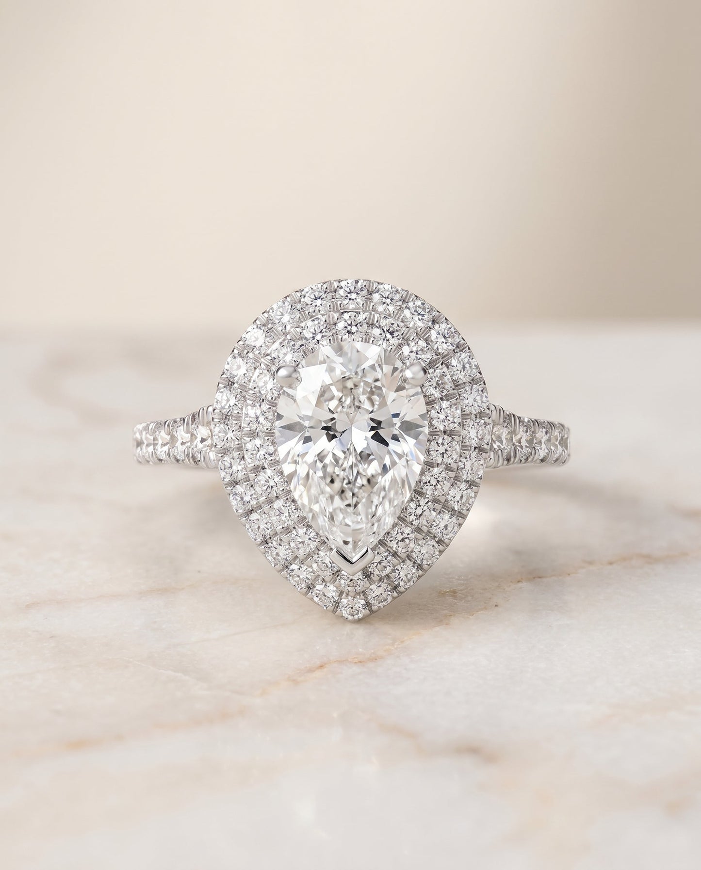 Britney Select Double Halo Pear Lab Diamond Engagement Ring in Platinum, shown on hand, angled | RockHer
