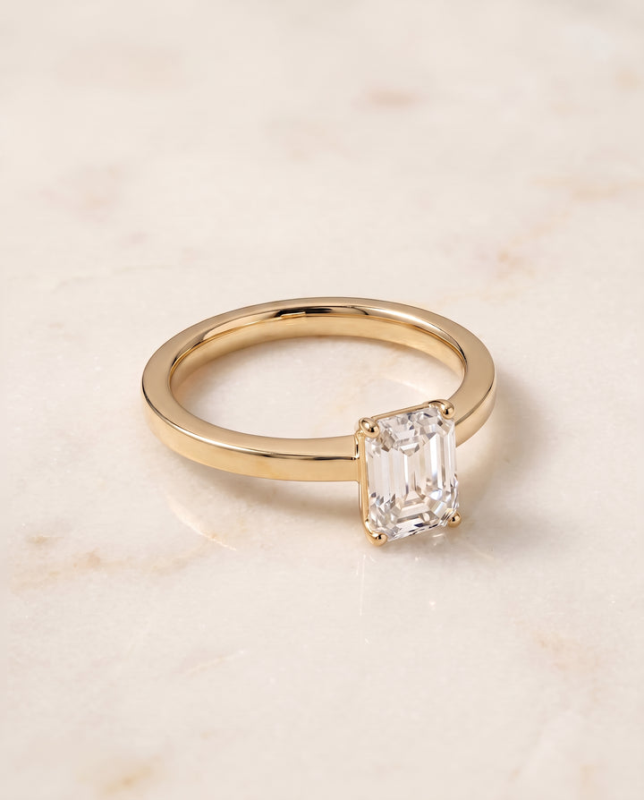 The Carmen Beveled Edge Comfort Fit Solitaire Emerald Cut Engagement Ring Setting in 18K Yellow Gold