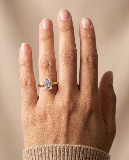 The Carmen Beveled Edge Comfort Fit Solitaire Emerald Cut Engagement Ring Setting in 18K Yellow Gold