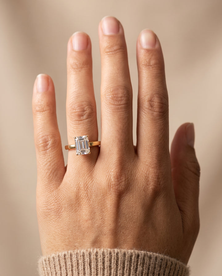 The Carmen Beveled Edge Comfort Fit Solitaire Emerald Cut Engagement Ring Setting in 18K Yellow Gold
