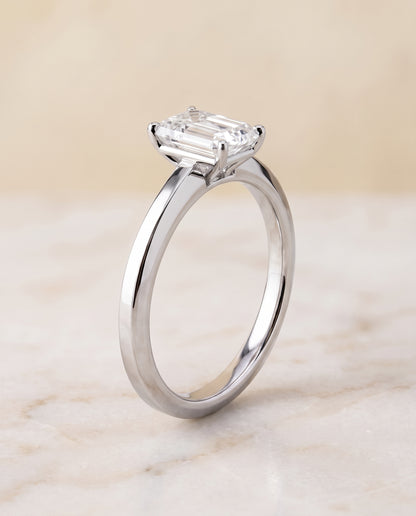 The Carmen Beveled Edge Comfort Fit Solitaire Emerald Cut Engagement Ring Setting in 18K White Gold