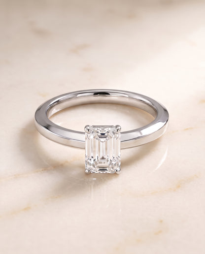 The Carmen Beveled Edge Comfort Fit Solitaire Emerald Cut Engagement Ring Setting in 18K White Gold