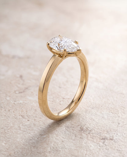 The Carmen Beveled Edge Comfort Fit Solitaire Pear Engagement Ring Setting in 18K Yellow Gold
