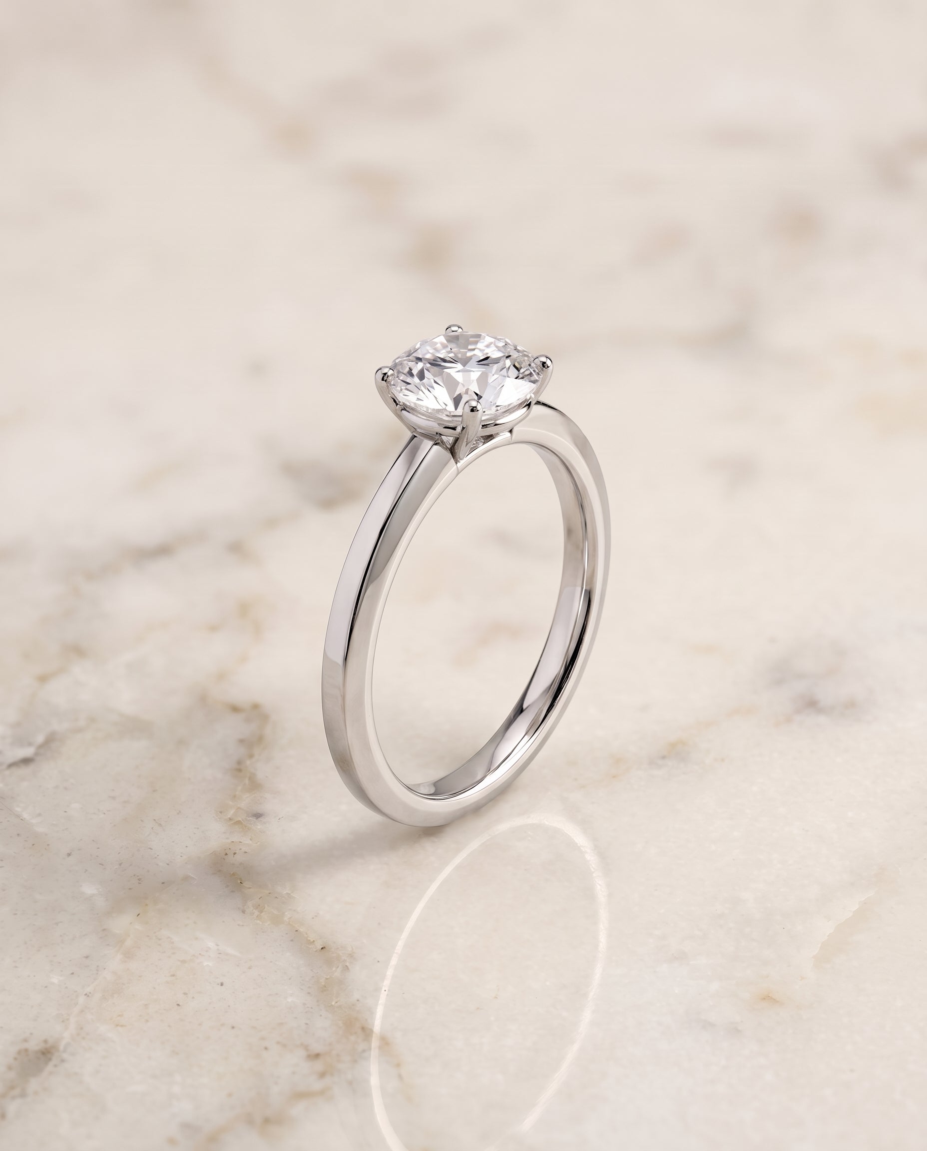 The Carmen Beveled Edge Comfort Fit Solitaire Round Engagement Ring Setting in 18K White Gold