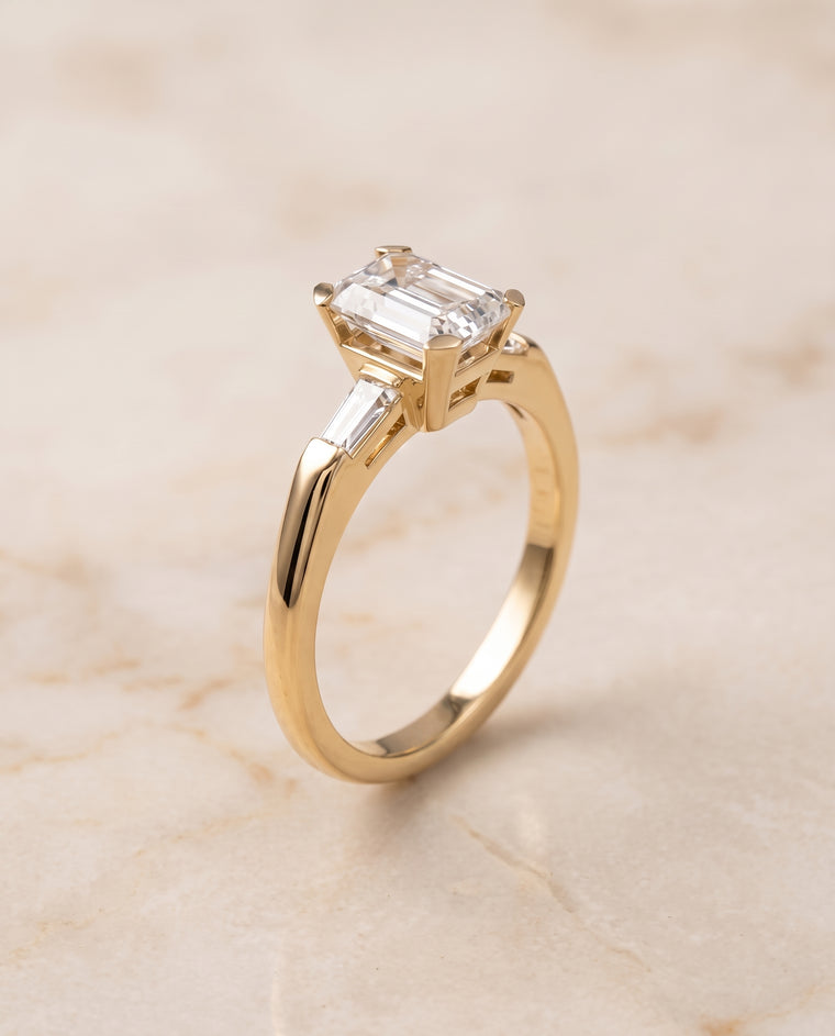 The Caroline Three Stone Emerald Cut Engagement Ring Setting in 18K Yellow Gold