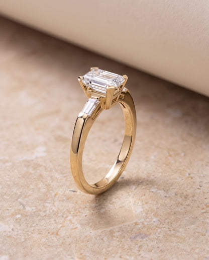 The Caroline Three Stone Emerald Cut Engagement Ring Setting in 18K Yellow Gold