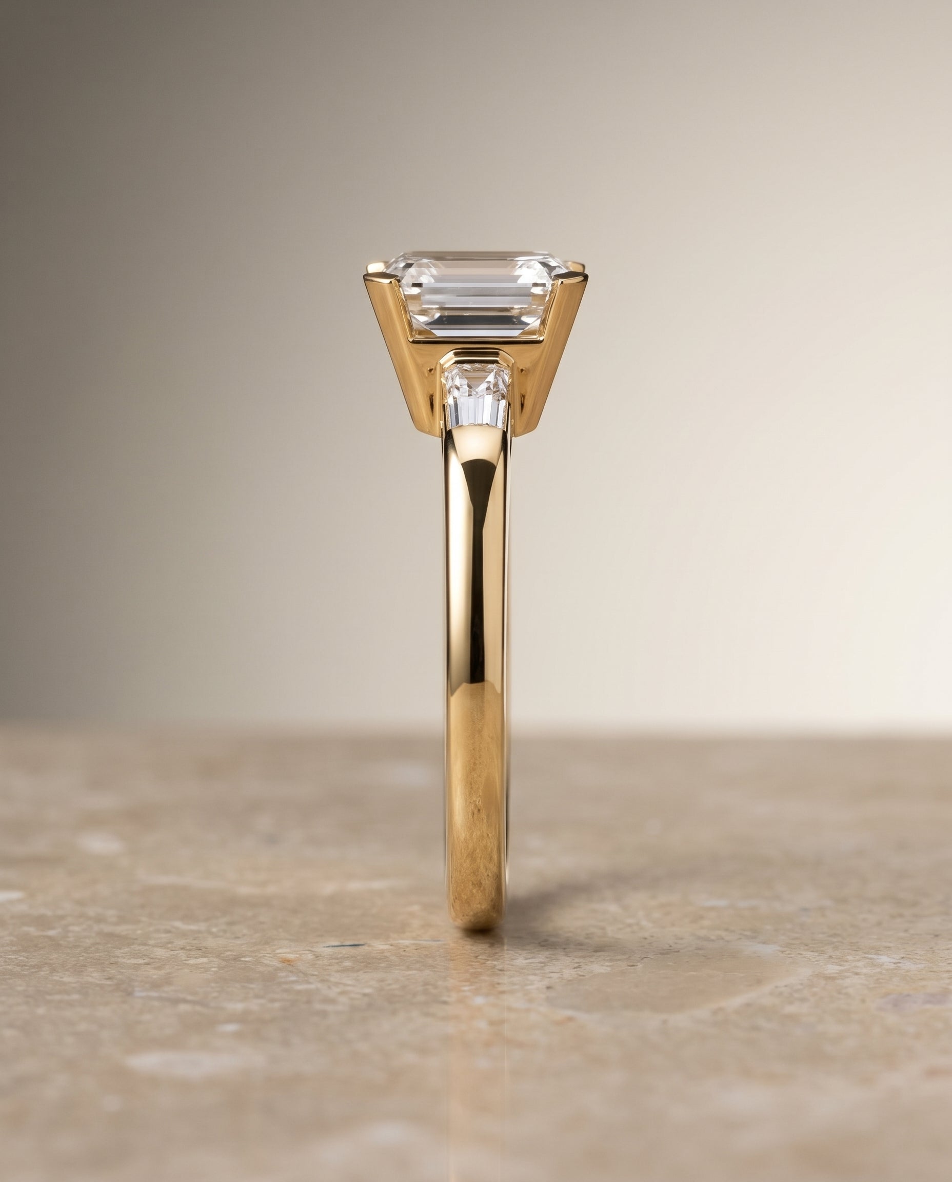 The Caroline Three Stone Emerald Cut Engagement Ring Setting in 18K Yellow Gold