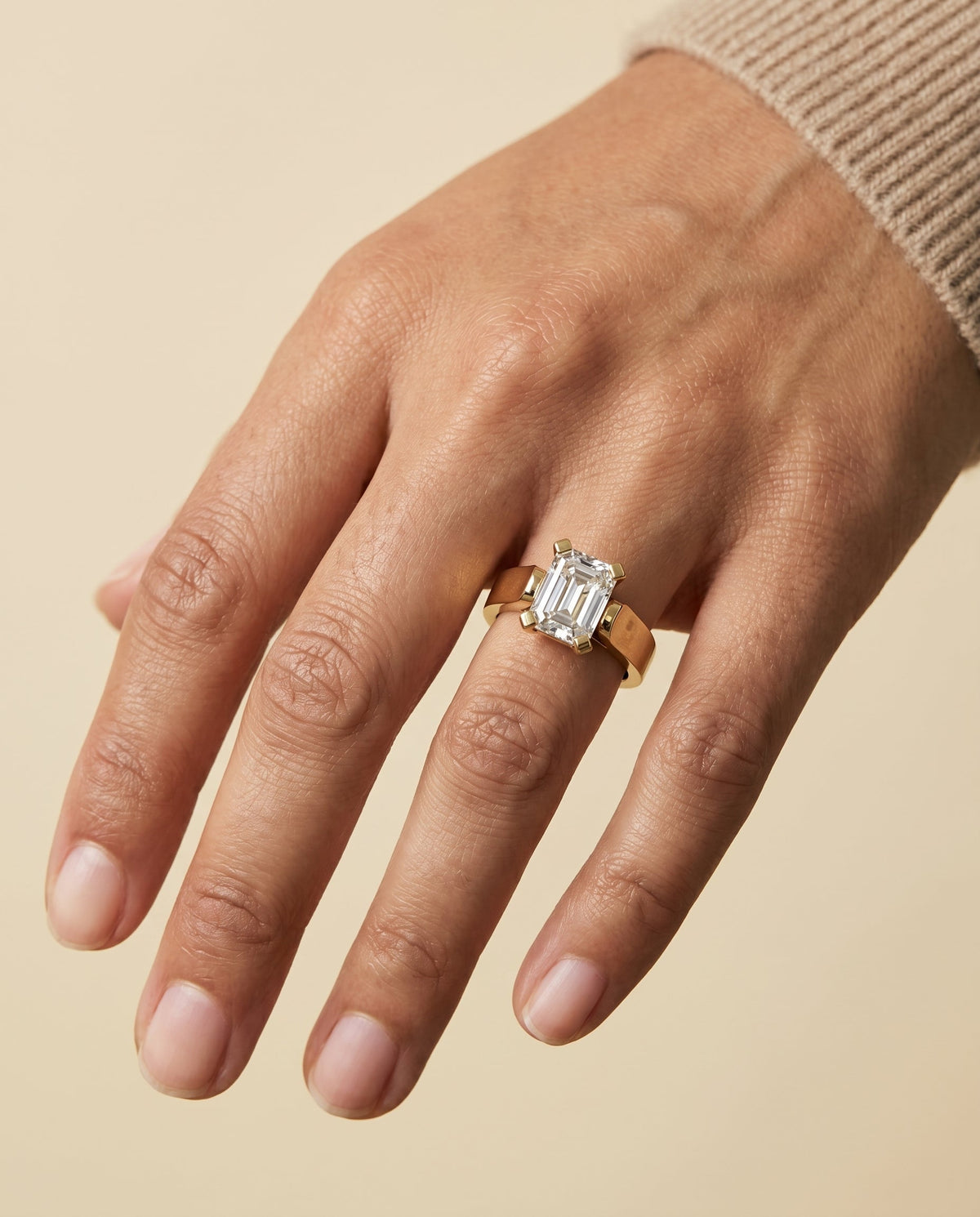 Charlotte Select Cathedral Solitaire Emerald Cut Lab Diamond Engagement Ring in 18K Yellow Gold, shown on hand | RockHer