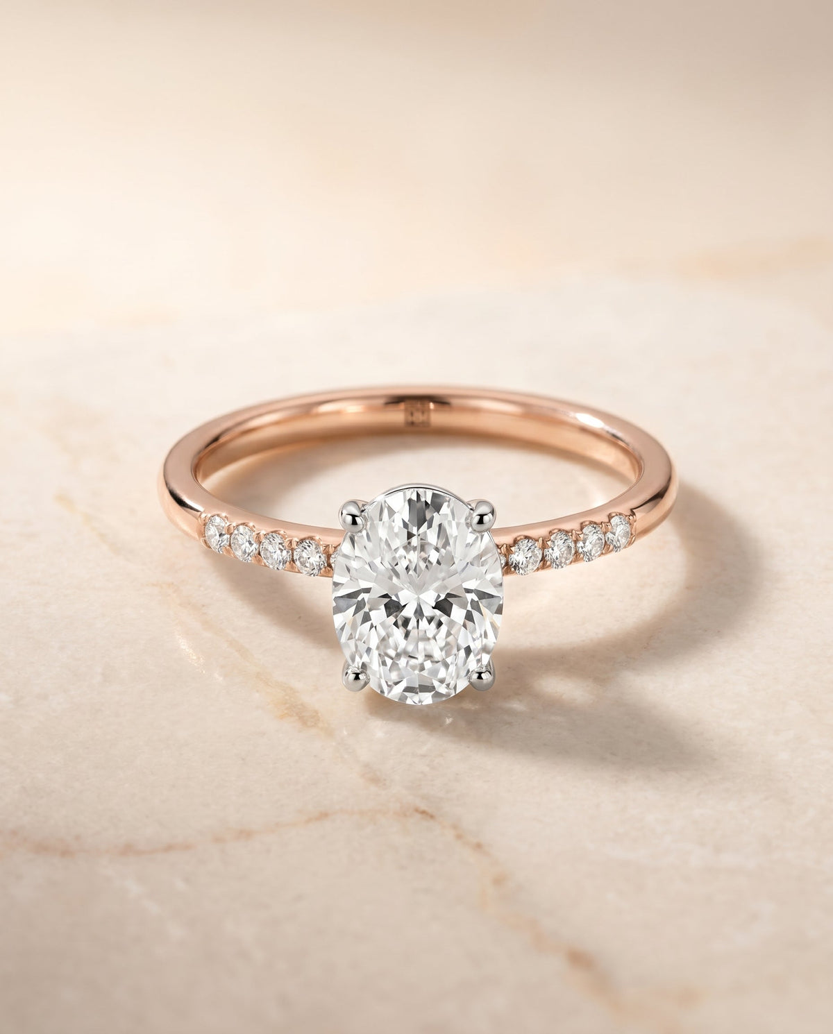 Cherie Select Hidden Halo Pavé Solitaire Oval Lab Diamond Engagement Ring in 14K Rose Gold, shown on hand, angled | RockHer