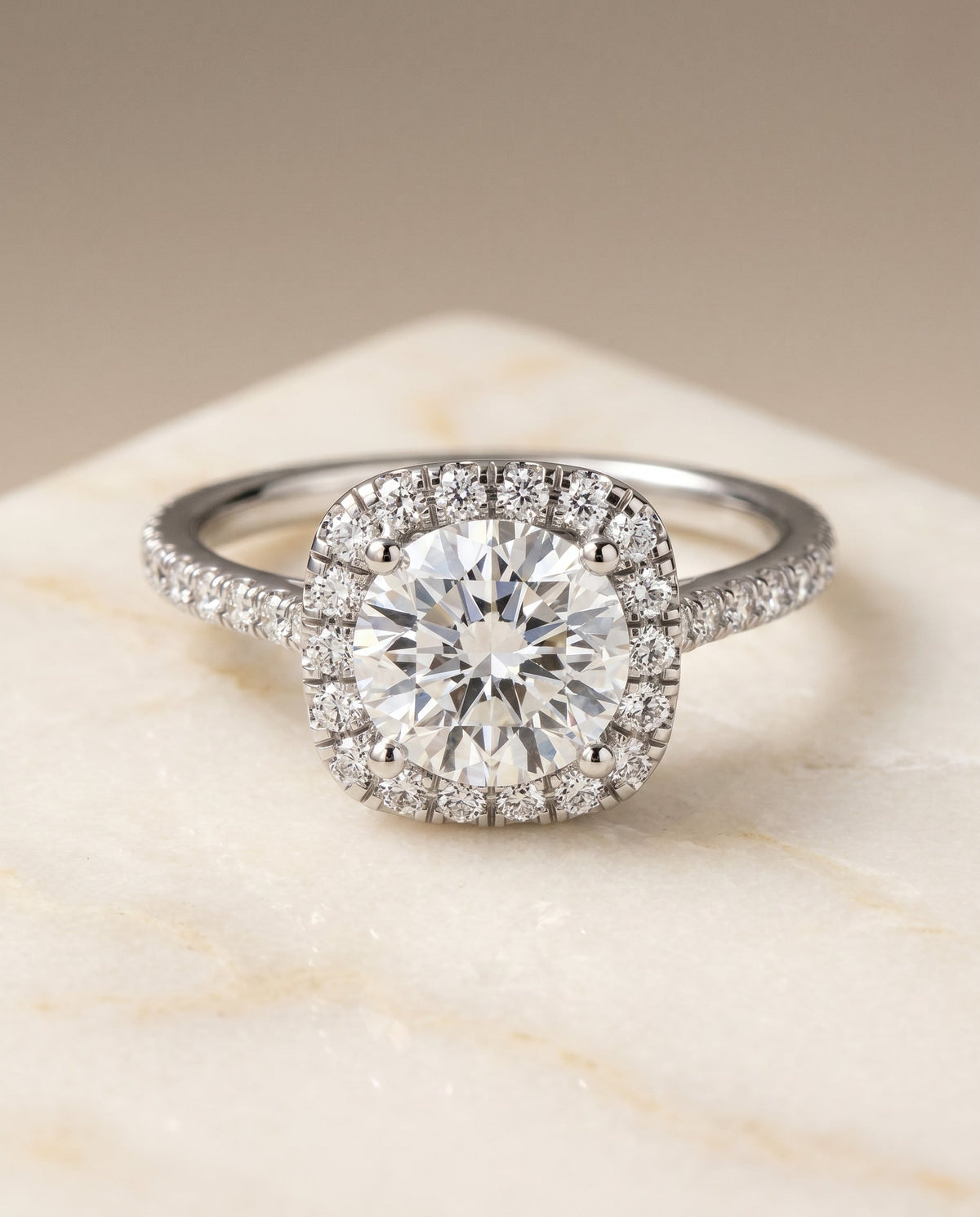 Cosette Select Halo Round Lab Diamond Engagement Ring in Platinum, shown on hand, angled | RockHer