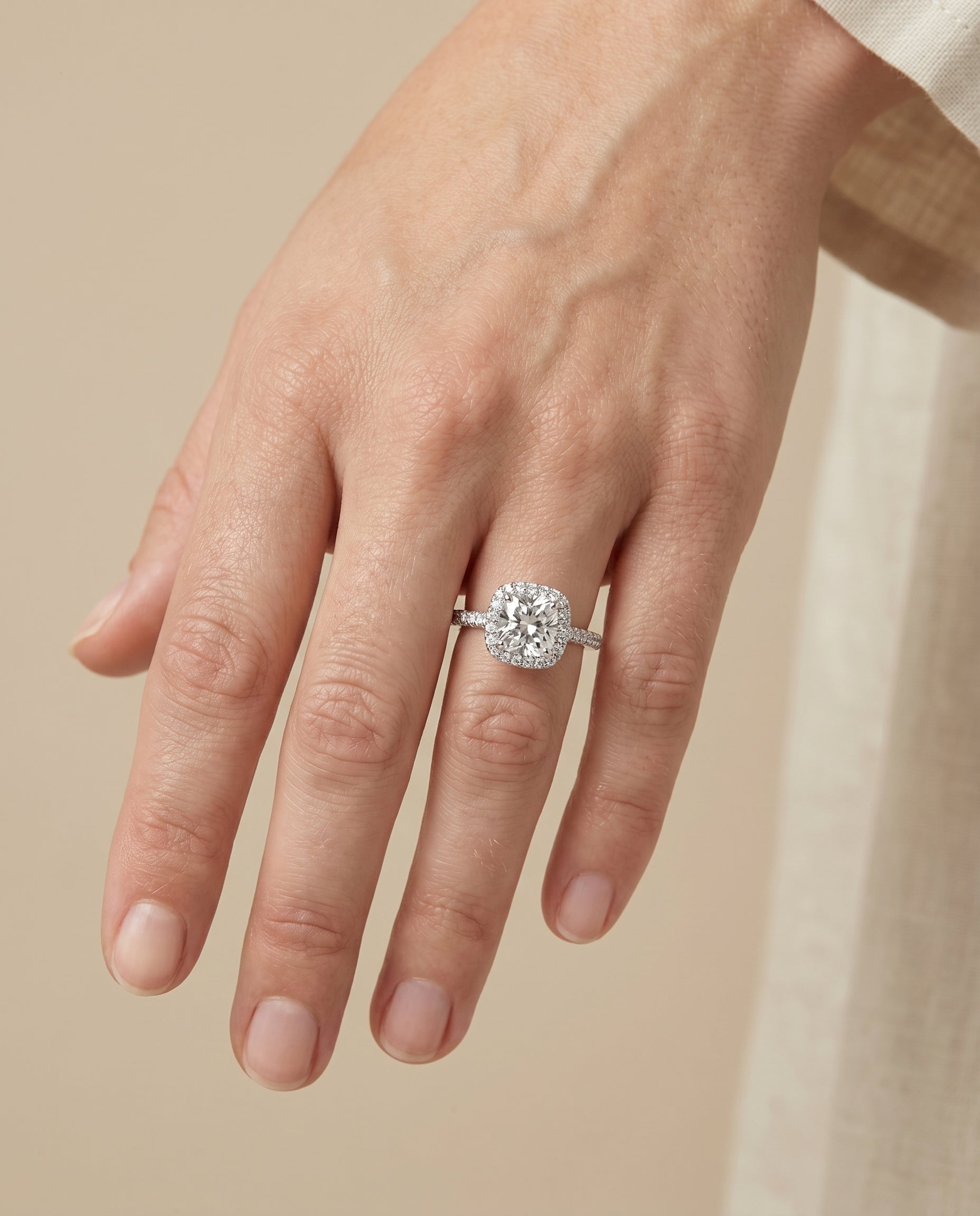 Cosette Select Pavé Halo Cushion Cut Lab Diamond Engagement Ring in Platinum, shown on hand | RockHer
