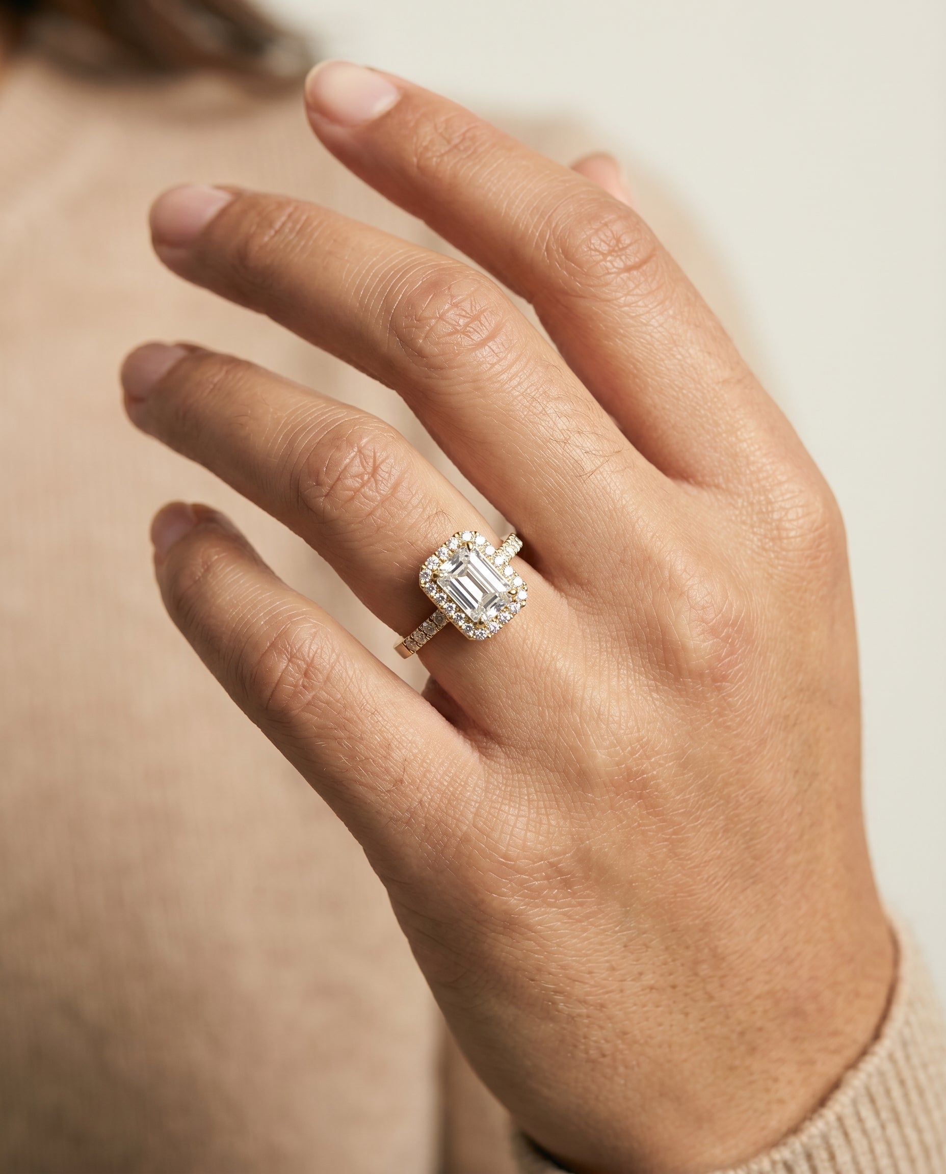 Crimson Select Halo Emerald Cut Lab Diamond Engagement Ring in 18K Yellow Gold, shown on hand | RockHer