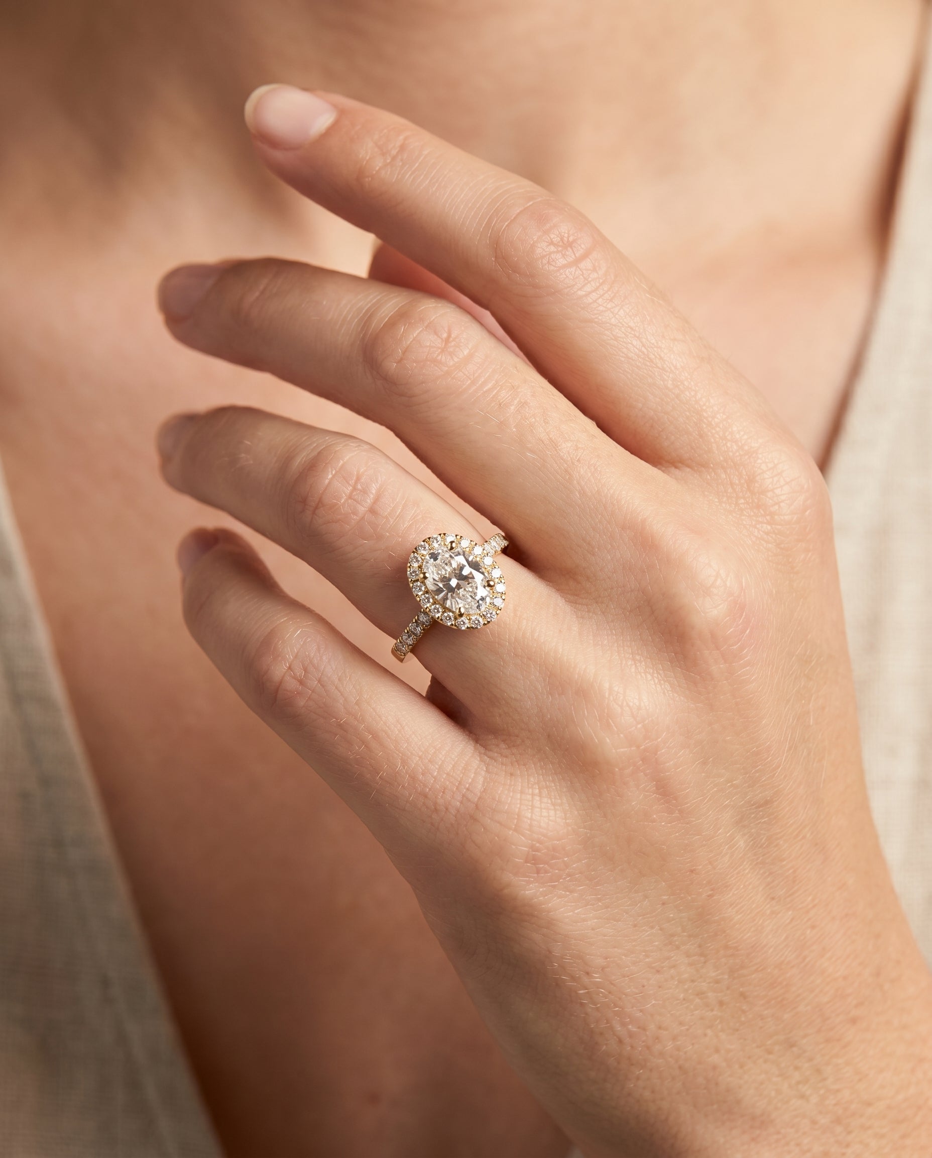 Crimson Select Halo Oval Lab Diamond Engagement Ring in 18K Yellow Gold, shown on hand | RockHer