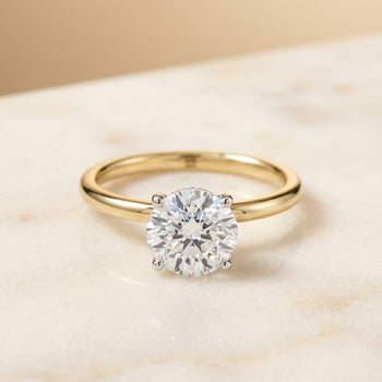 The Cyndi Curved Hidden Halo Solitaire Round Engagement Ring Setting in 18K Yellow Gold