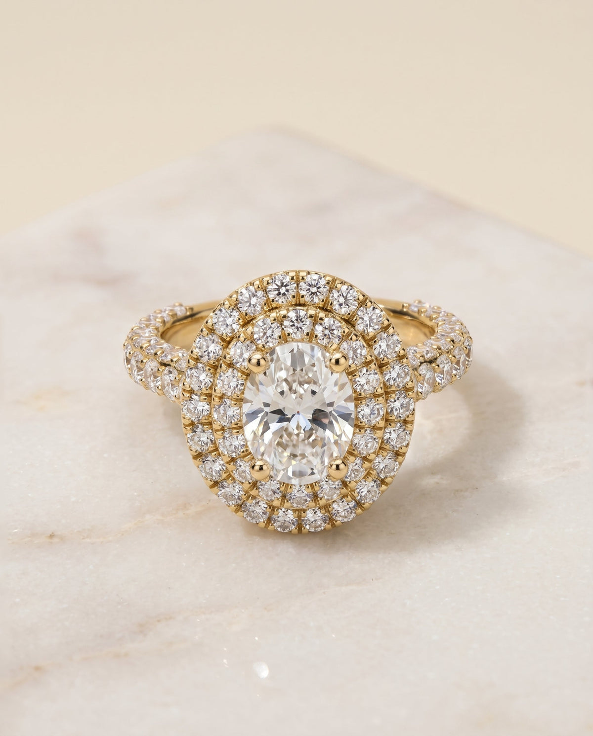 Dinah Select Double Halo Oval Lab Diamond Engagement Ring in 18K Yellow Gold, shown on hand, angled | RockHer