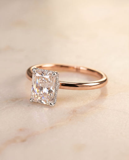 Dolly Select Double Hidden Halo Solitaire Radiant Cut Lab Diamond Engagement Ring in 14K Rose Gold, shown on hand, angled | RockHer