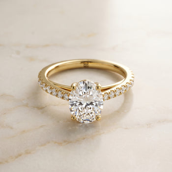 The Donna Cathedral French Pavé Solitaire Oval Engagement Ring Setting in 18K Yellow Gold