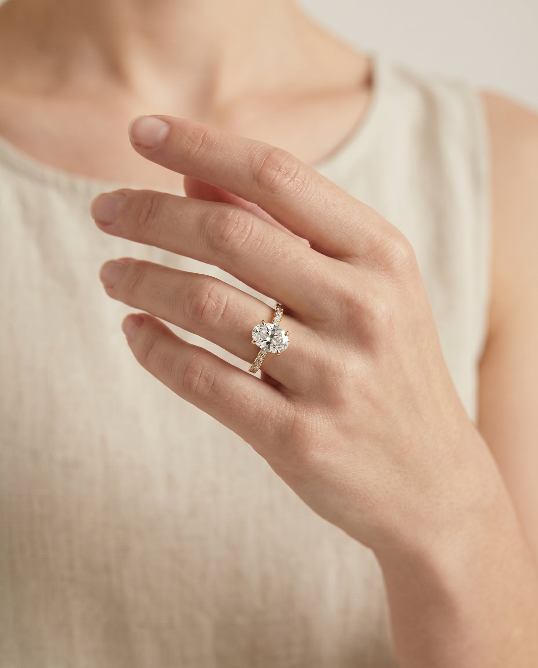 Donna Select Cathedral French Pavé Solitaire Oval Lab Diamond Engagement Ring in 18K Yellow Gold, shown on hand | RockHer