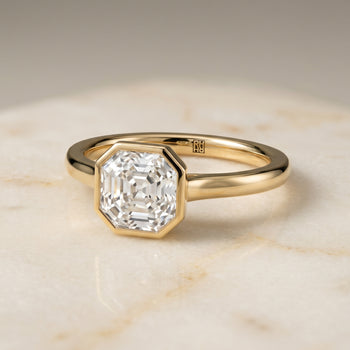 The Duran Simple Bezel Solitaire Asscher Cut Engagement Ring Setting in 18K Yellow Gold