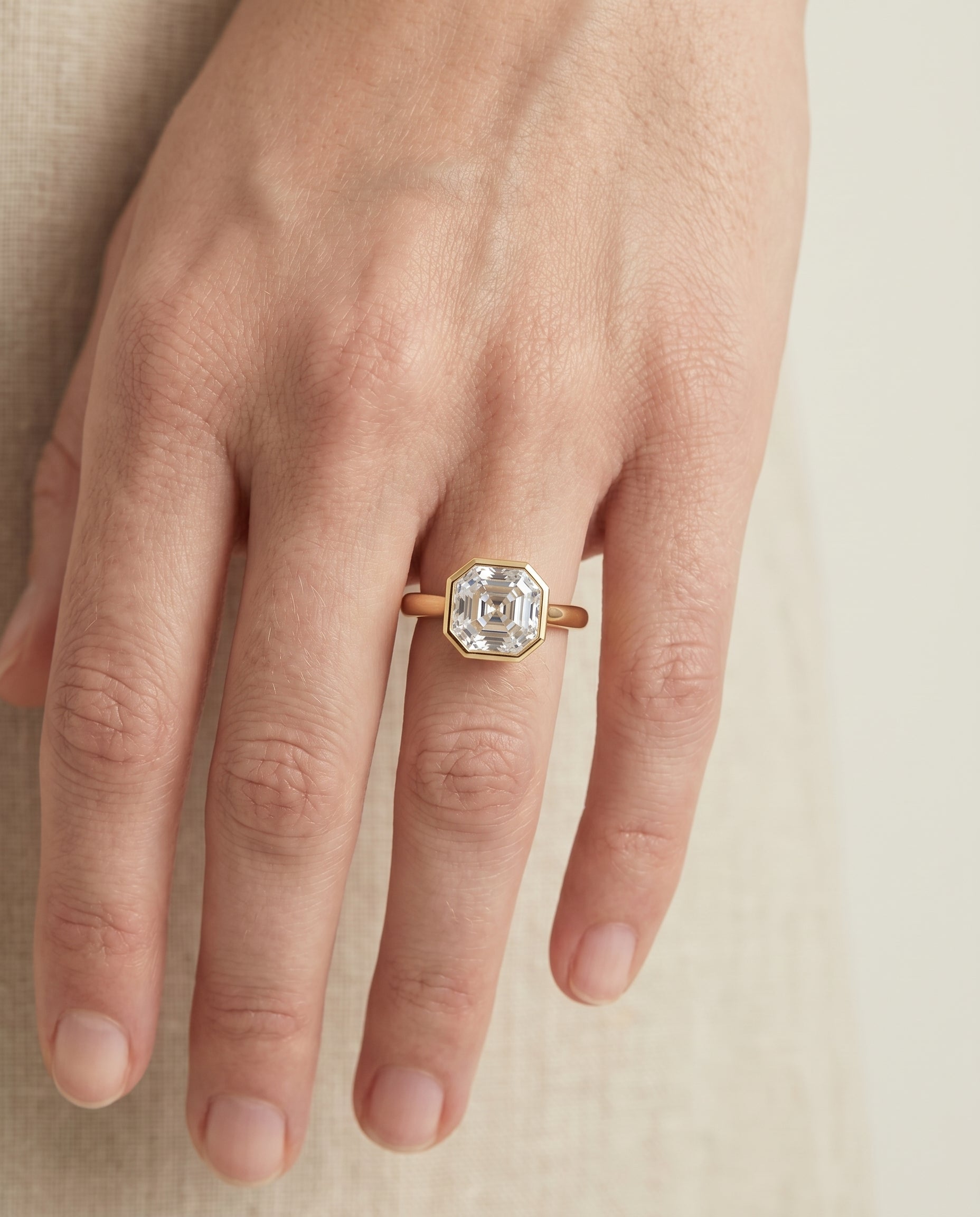 The Duran engagement ring setting in 18K Yellow Gold, simple bezel solitaire cut design | RockHer