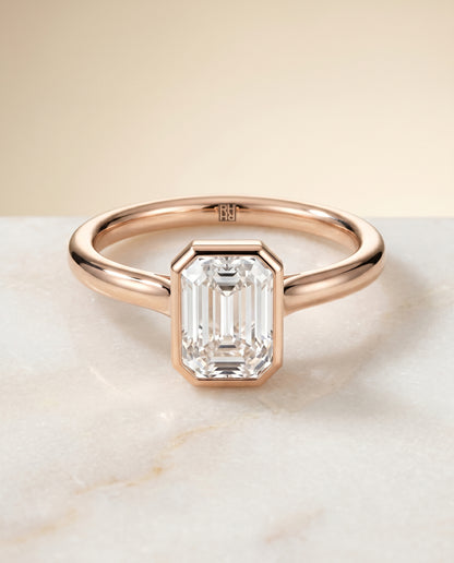The Duran Simple Bezel Solitaire Emerald Cut Engagement Ring Setting in 14K Rose Gold