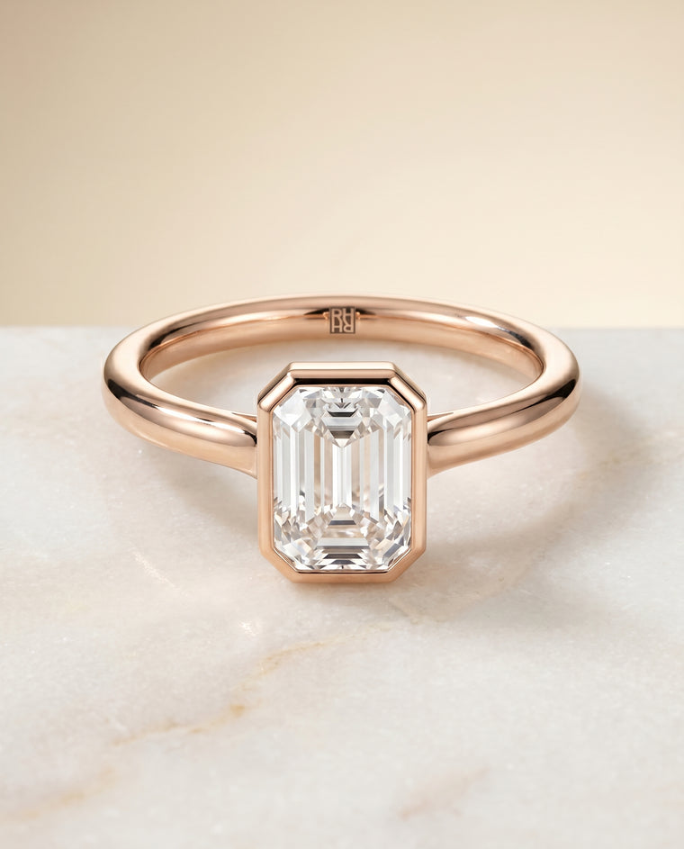 The Duran Simple Bezel Solitaire Emerald Cut Engagement Ring Setting in 14K Rose Gold