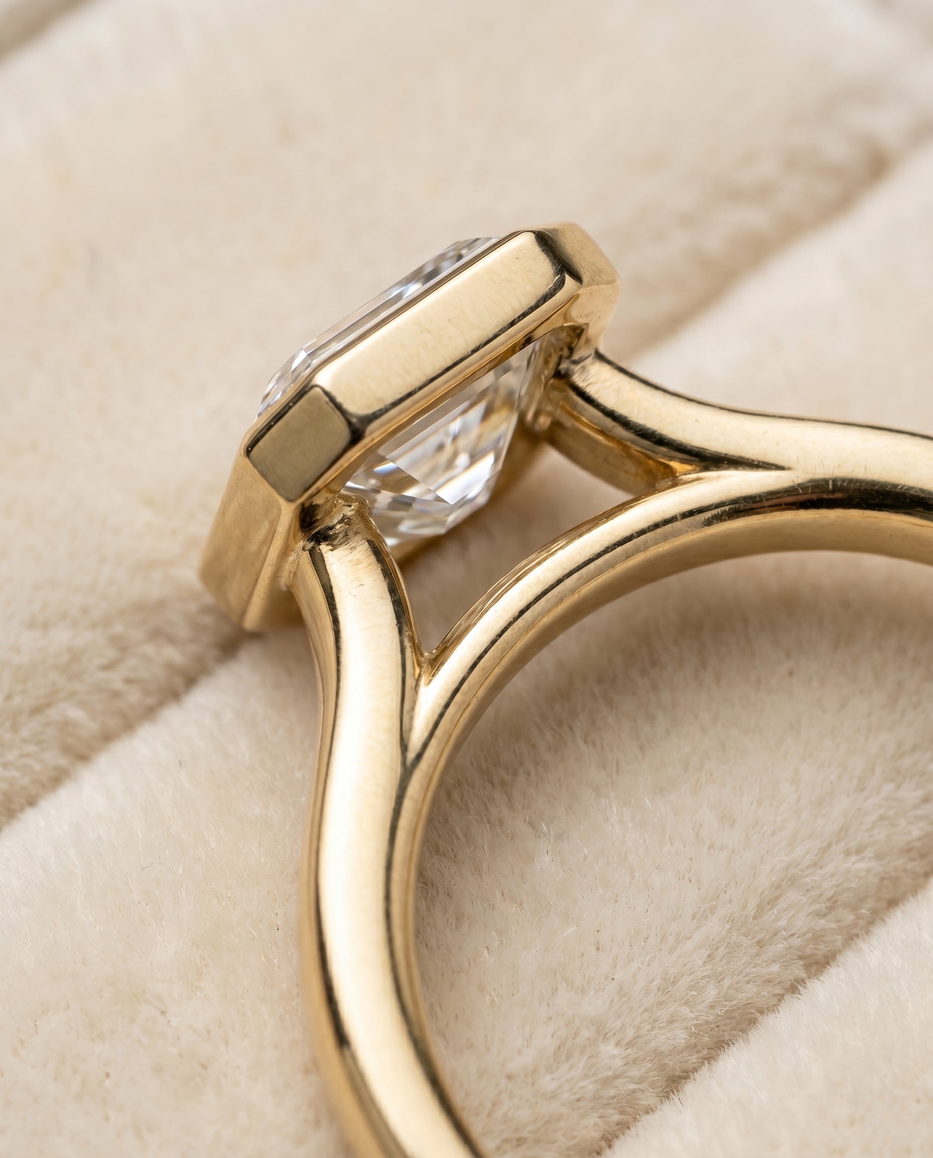 Duran Select Simple Bezel Solitaire Emerald Cut Lab Diamond Engagement Ring in 18K Yellow Gold, detail view | RockHer