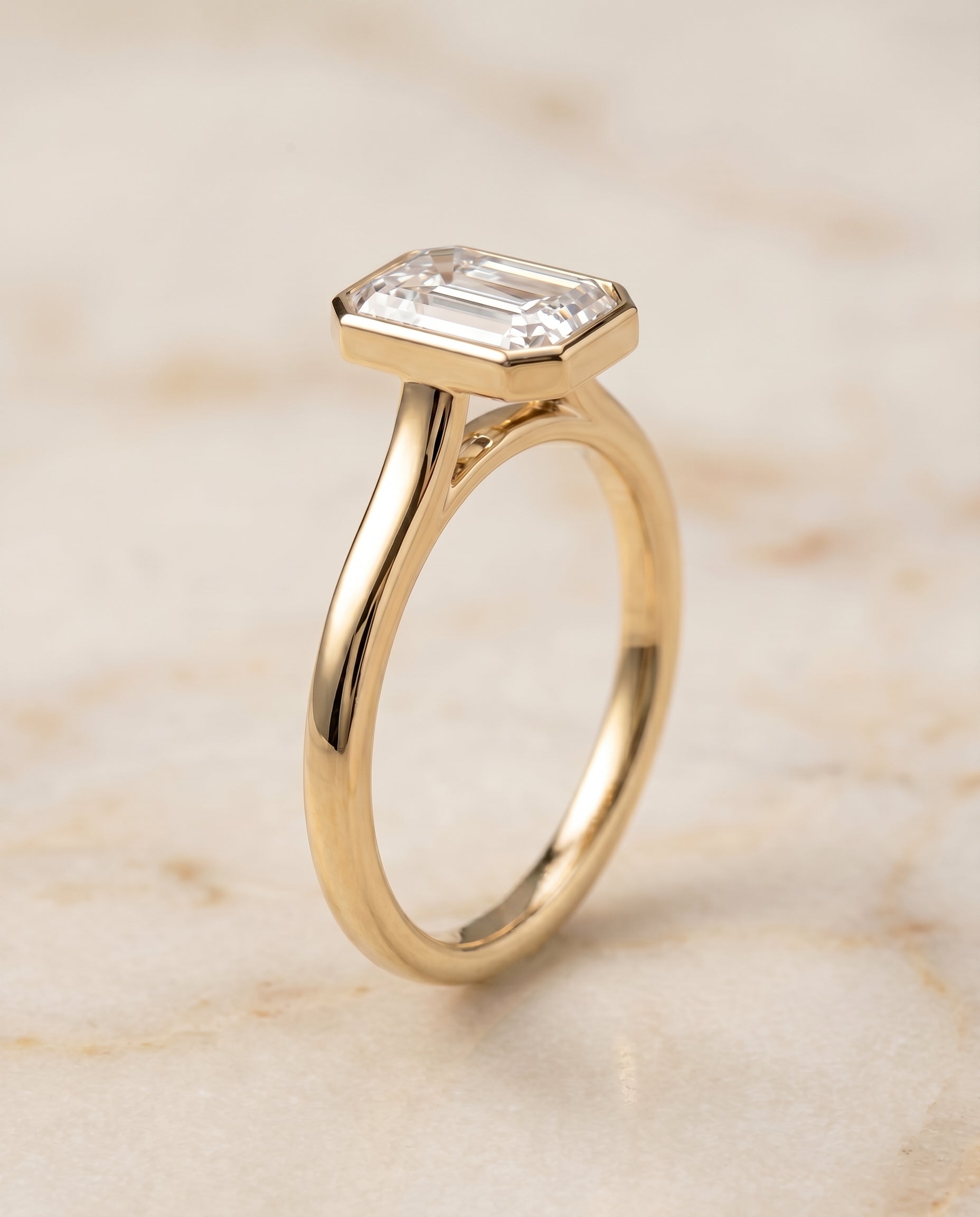 Duran Select Simple Bezel Solitaire Emerald Cut Lab Diamond Engagement Ring in 18K Yellow Gold, front view | RockHer