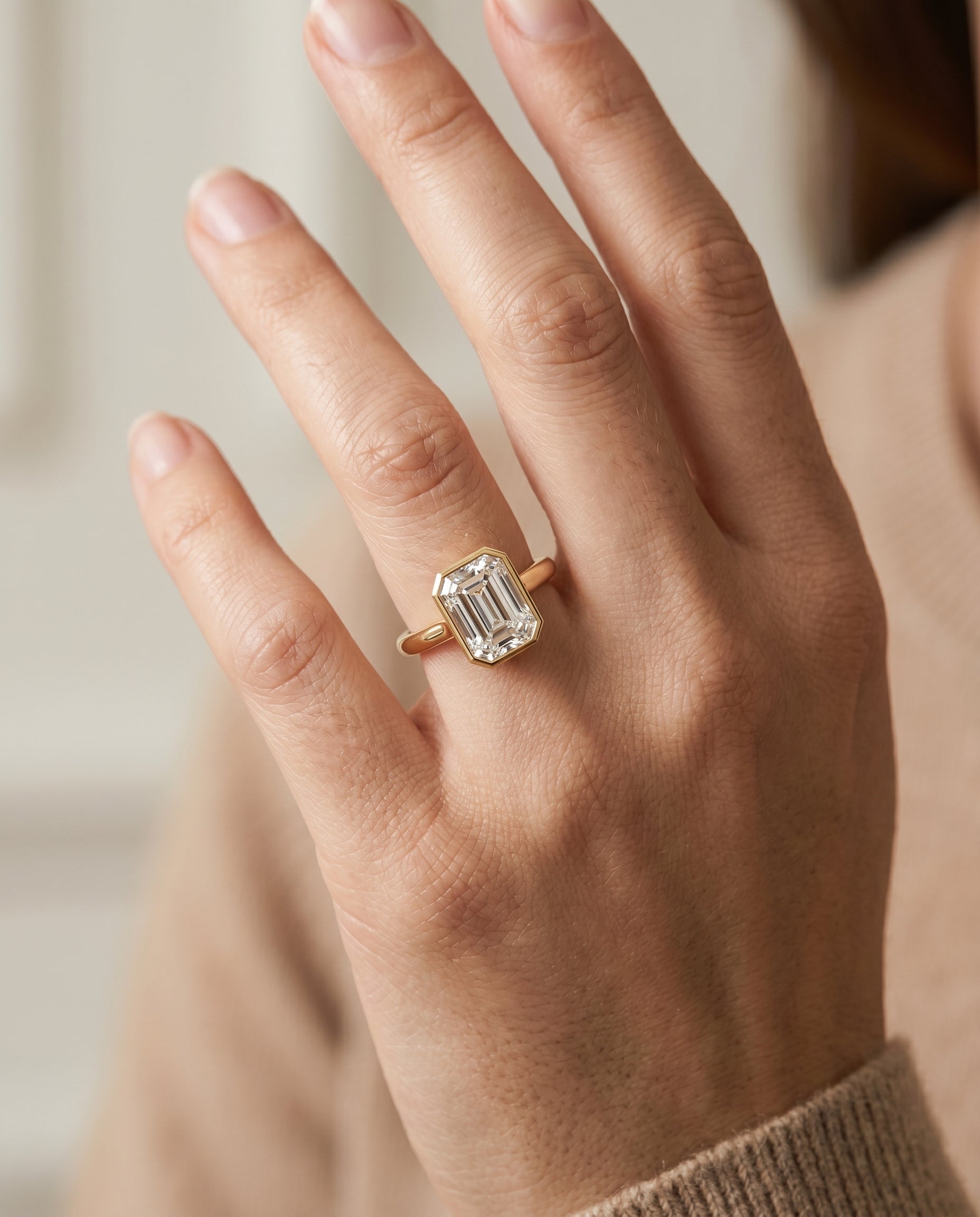 Duran Select Simple Bezel Solitaire Emerald Cut Lab Diamond Engagement Ring in 18K Yellow Gold, shown on hand | RockHer