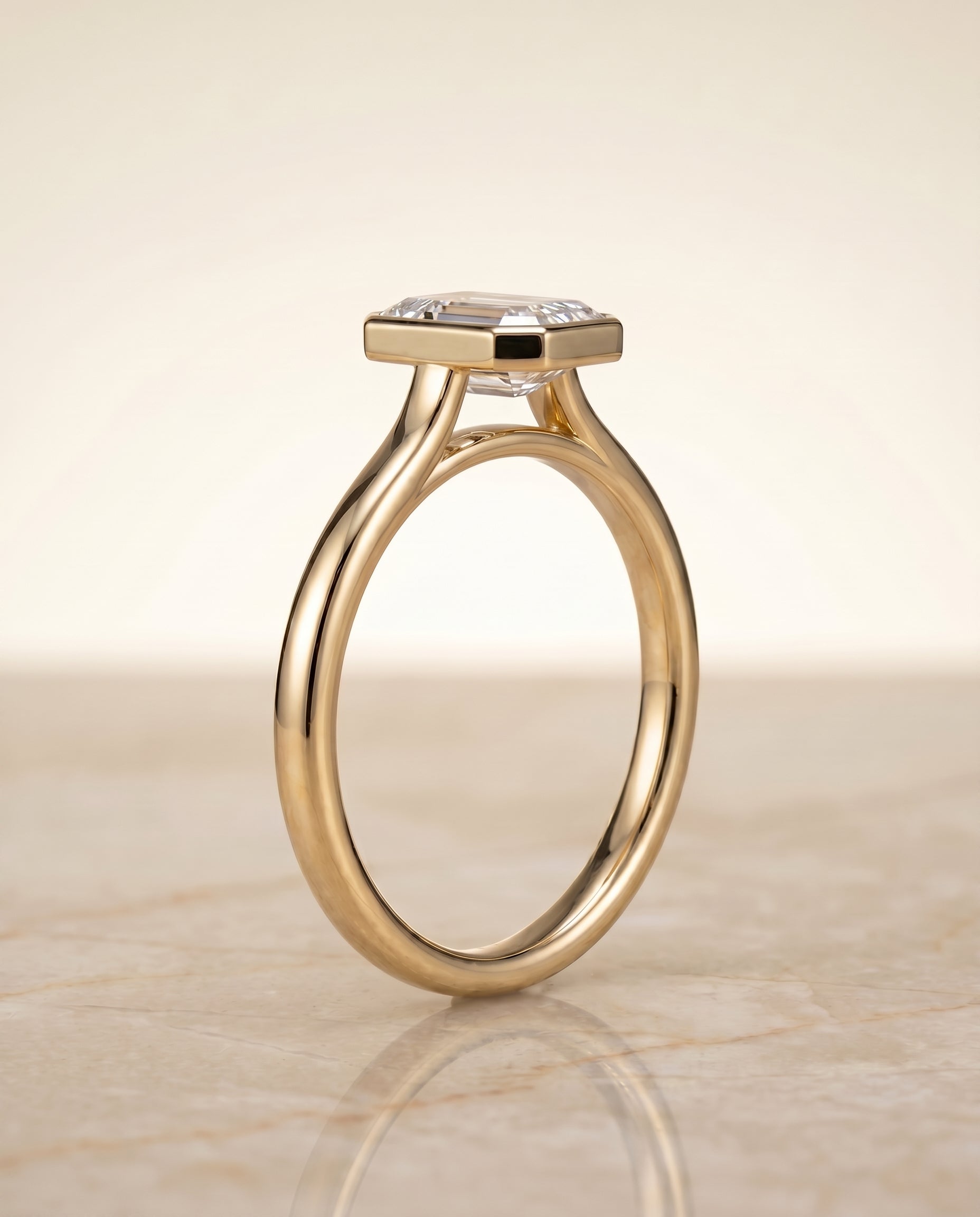 Duran Select Simple Bezel Solitaire Emerald Cut Lab Diamond Engagement Ring in 18K Yellow Gold, side view | RockHer