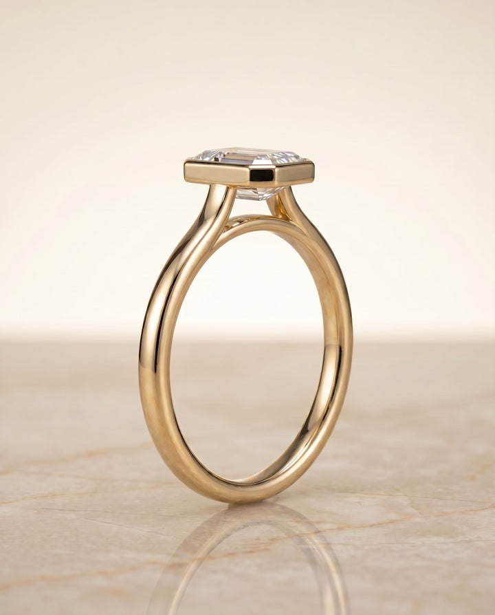Duran Select Simple Bezel Solitaire Emerald Cut Lab Diamond Engagement Ring in 18K Yellow Gold, side view | RockHer