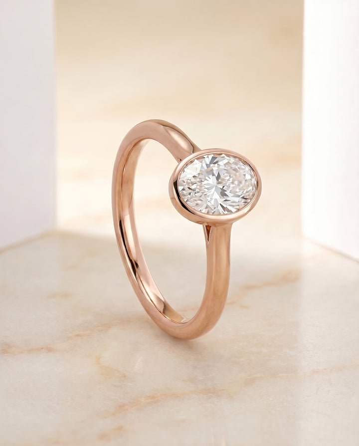 The Duran Simple Bezel Solitaire Engagement Ring Setting for Oval Diamonds in 14K Rose Gold