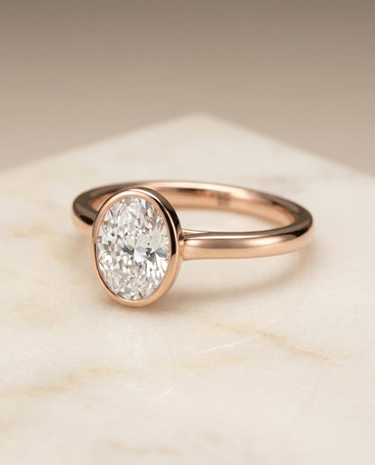 The Duran Simple Bezel Solitaire Oval Engagement Ring Setting in 14K Rose Gold