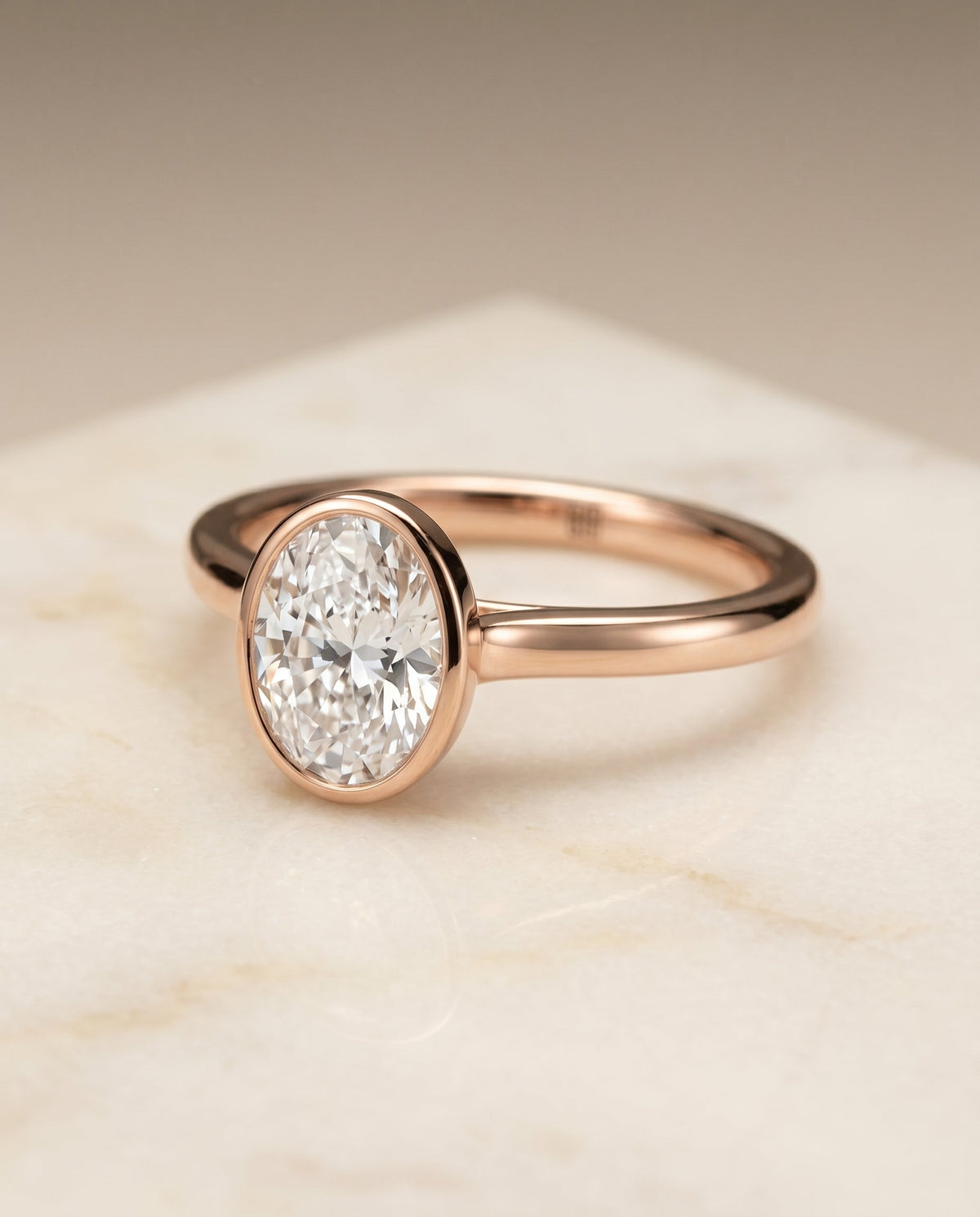 Duran Select Simple Bezel Solitaire Oval Lab Diamond Engagement Ring in 14K Rose Gold, shown on hand, angled | RockHer