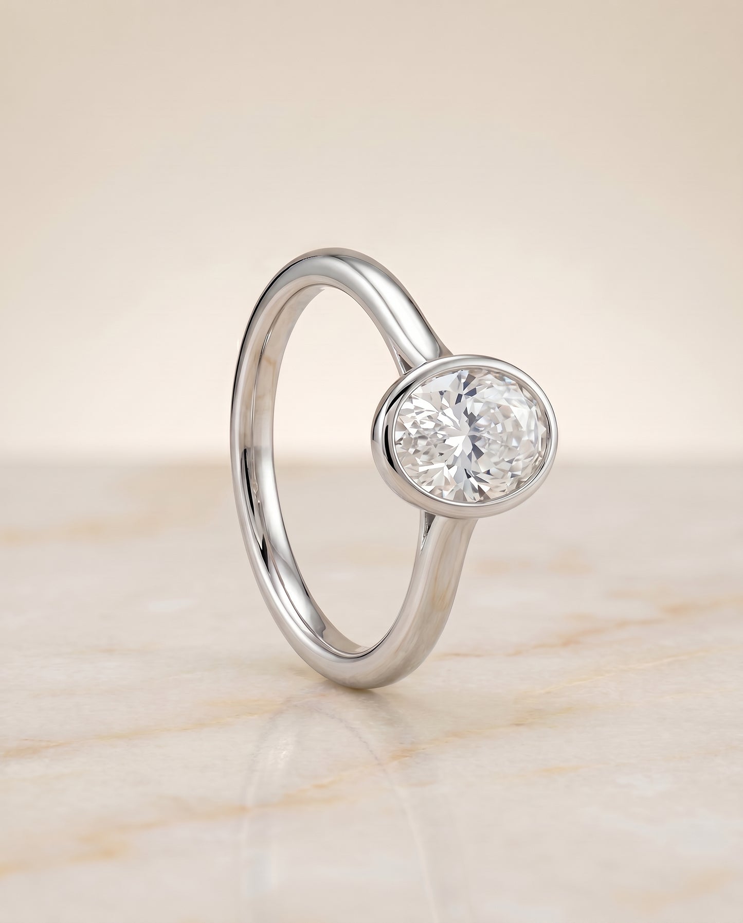 The Duran Simple Bezel Solitaire Engagement Ring Setting for Oval Diamonds in 18K White Gold