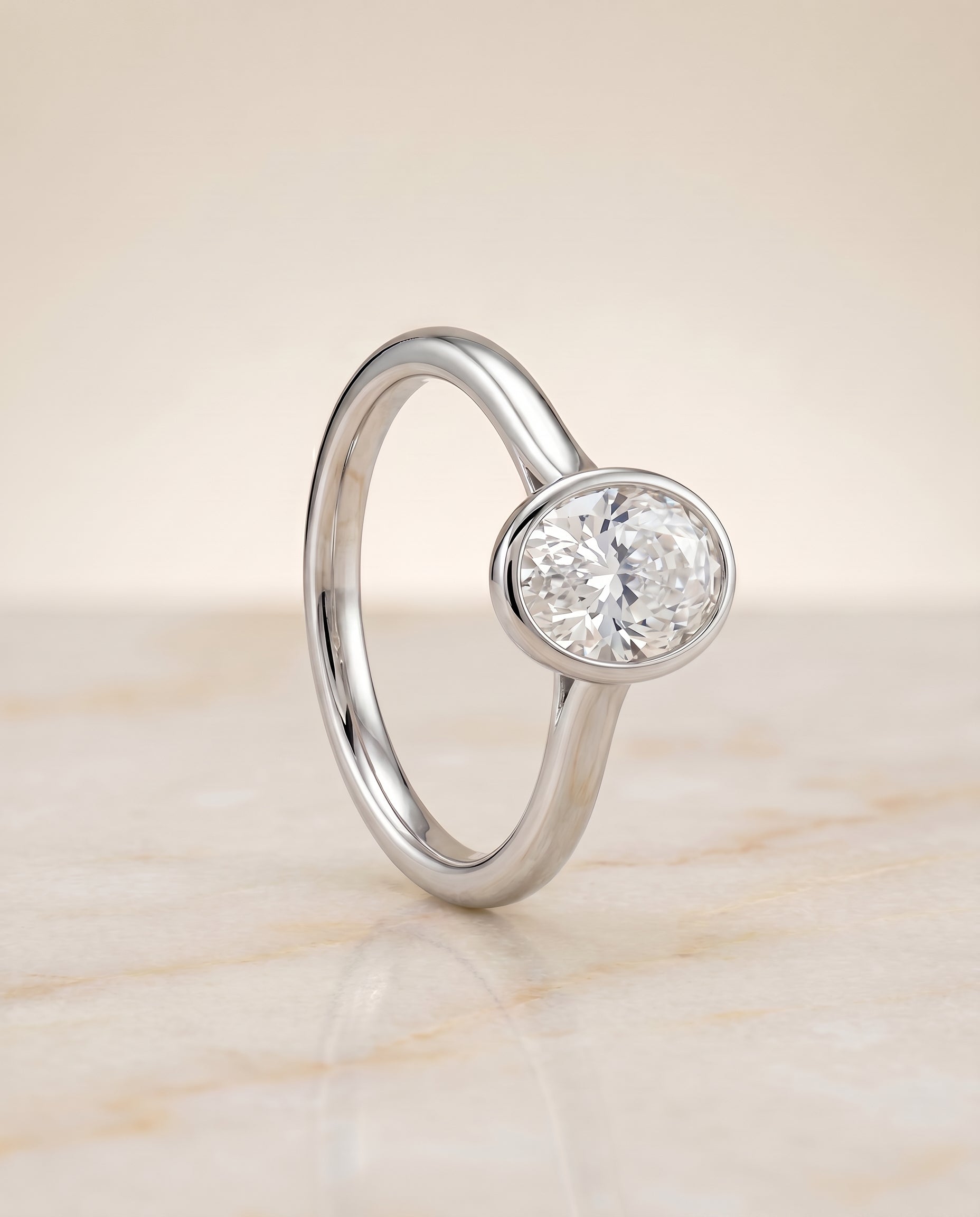 Simple Bezel Solitaire styling on The Duran oval engagement ring setting | RockHer
