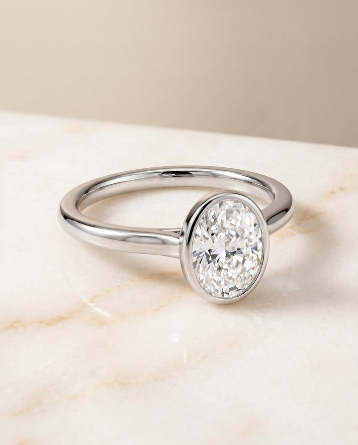 The Duran Simple Bezel Solitaire Oval Engagement Ring Setting in Platinum
