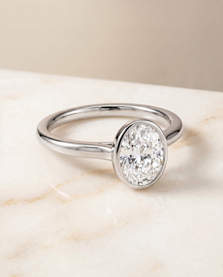 The Duran Select Simple Bezel Solitaire Oval Lab Diamond Engagement Ring in Platinum