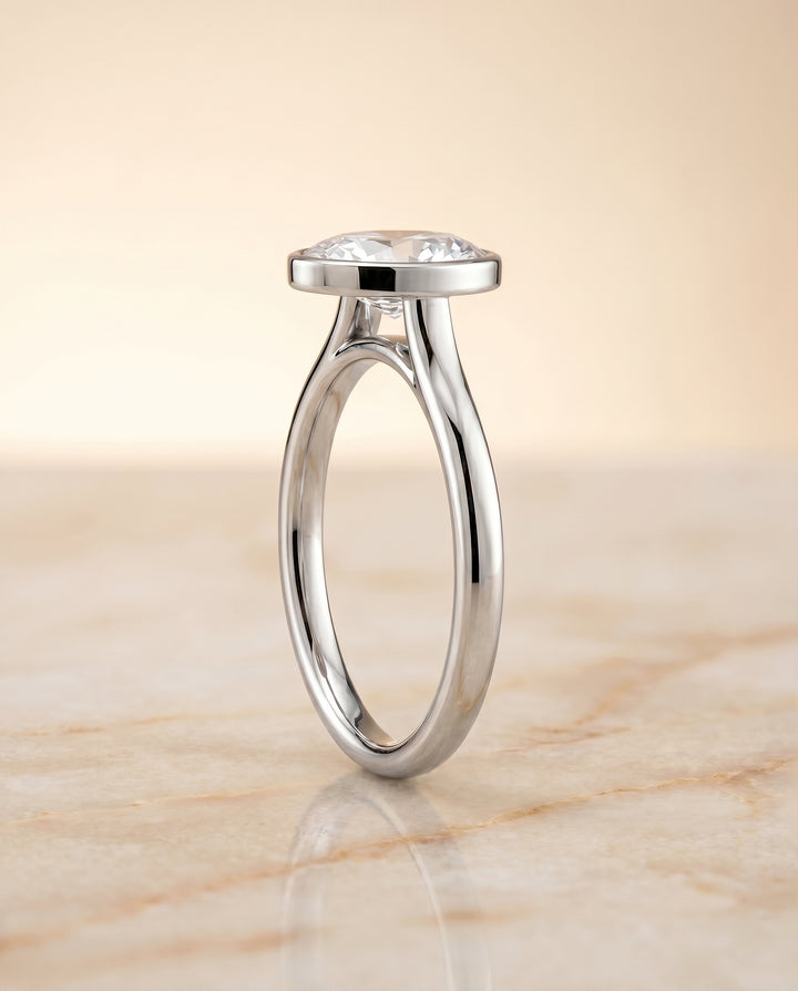 The Duran Simple Bezel Solitaire Engagement Ring Setting for Oval Diamonds in 18K White Gold