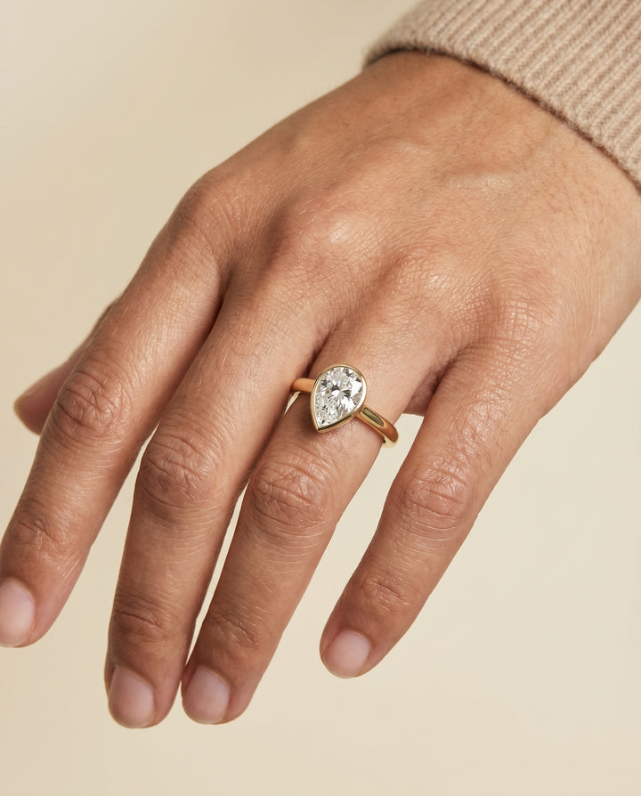 The Duran Simple Bezel Solitaire Engagement Ring Setting for Pear Diamonds in 18K Yellow Gold