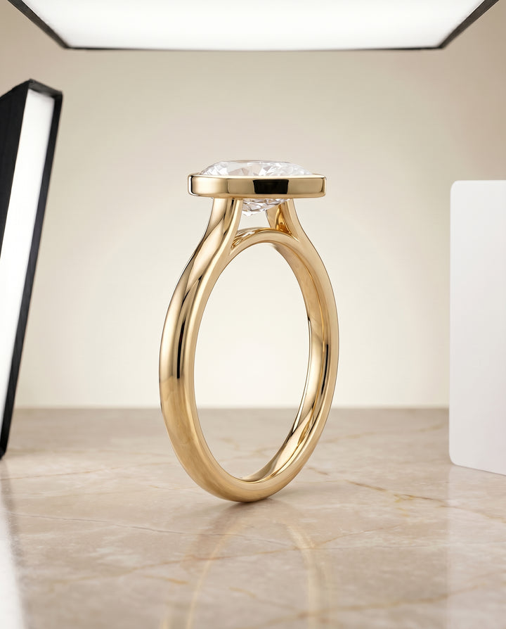 The Duran Simple Bezel Solitaire Engagement Ring Setting for Pear Diamonds in 18K Yellow Gold