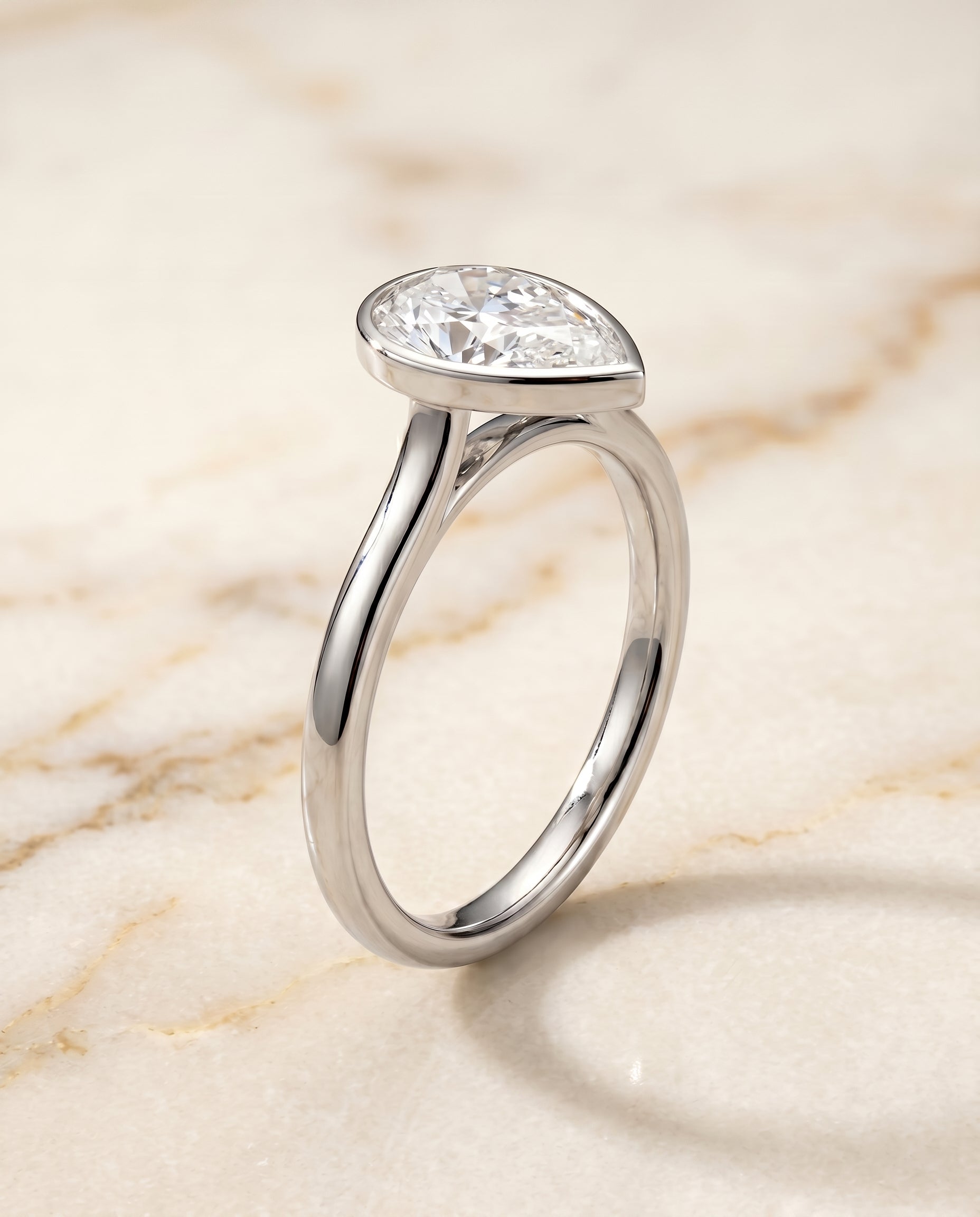 Duran Select Simple Bezel Solitaire Pear Lab Diamond Engagement Ring in Platinum, front view | RockHer