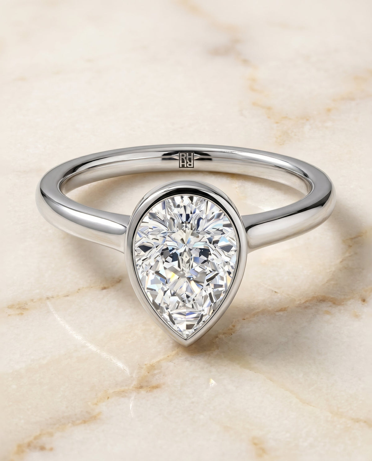 Duran Select Simple Bezel Solitaire Pear Lab Diamond Engagement Ring in Platinum, shown on hand, angled | RockHer