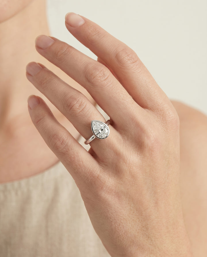 The Duran Bezel Solitaire Engagement Ring Setting for Pear Diamonds in 18K White Gold