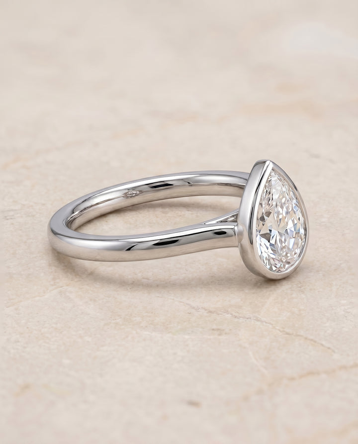 The Duran Bezel Solitaire Engagement Ring Setting for Pear Diamonds in 18K White Gold