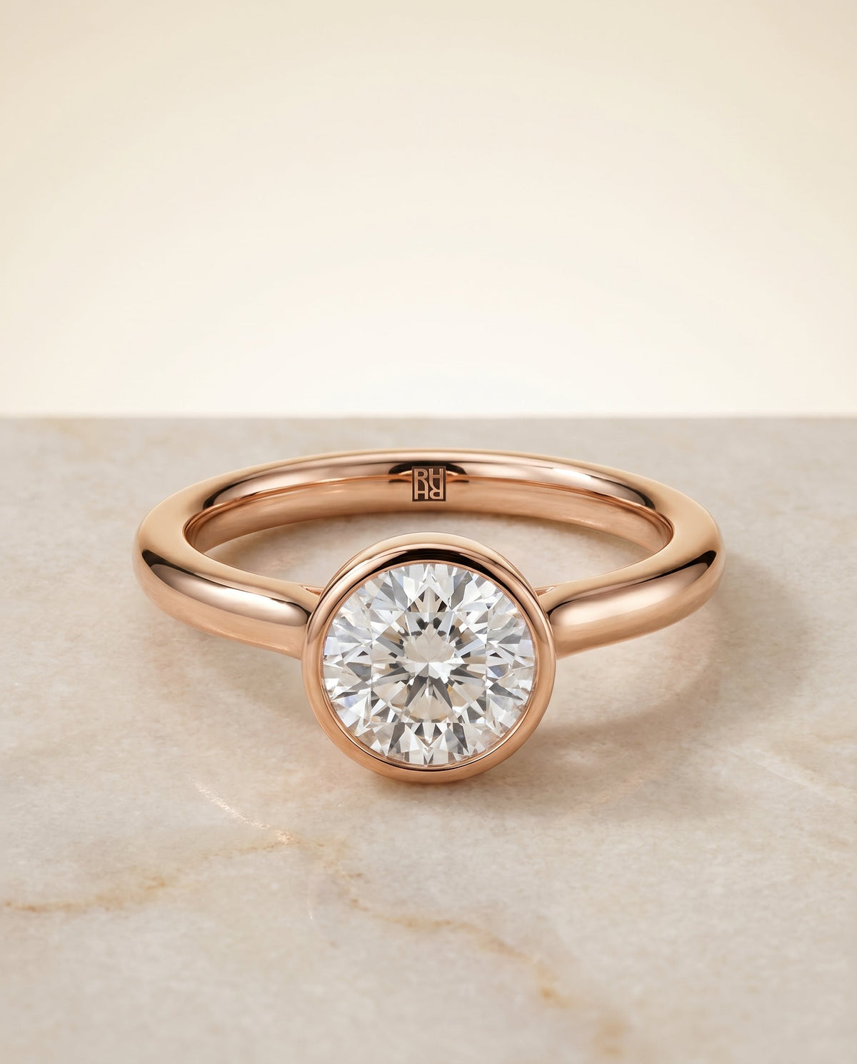 Duran Select Simple Bezel Solitaire Round Lab Diamond Engagement Ring in 14K Rose Gold, shown on hand, angled | RockHer