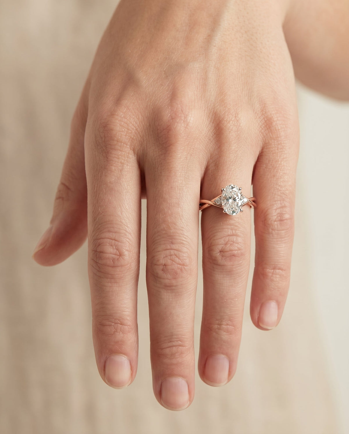 Dusty Select Hidden Halo Solitaire Oval Lab Diamond Engagement Ring in 14K Rose Gold, shown on hand | RockHer