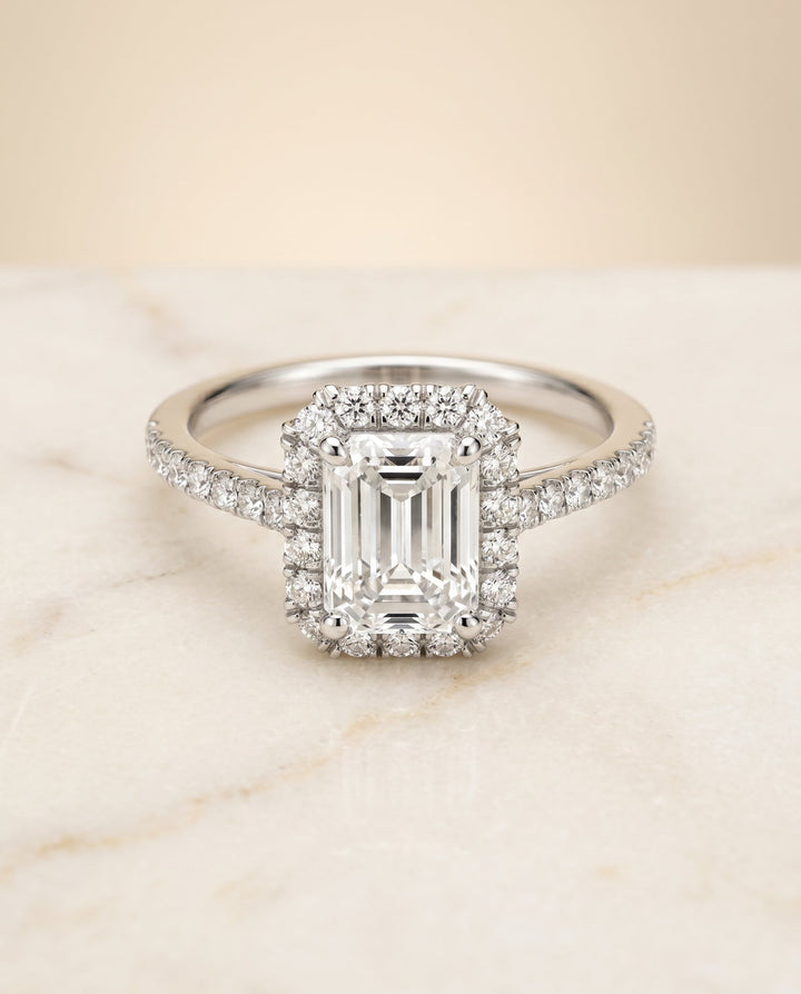 Dylan Select Petite French Pavé Halo Emerald Cut Lab Diamond Engagement Ring in Platinum, shown on hand, angled | RockHer