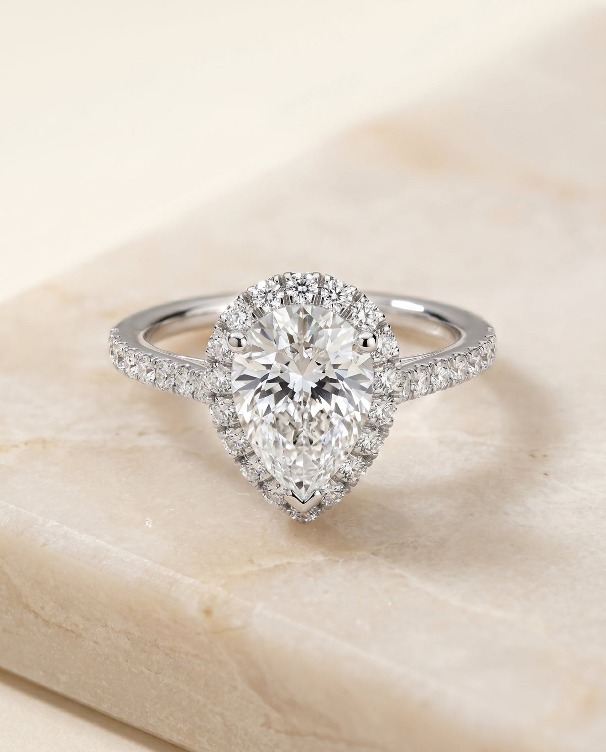 Dylan Select Halo Pear Lab Diamond Engagement Ring in Platinum, shown on hand, angled | RockHer