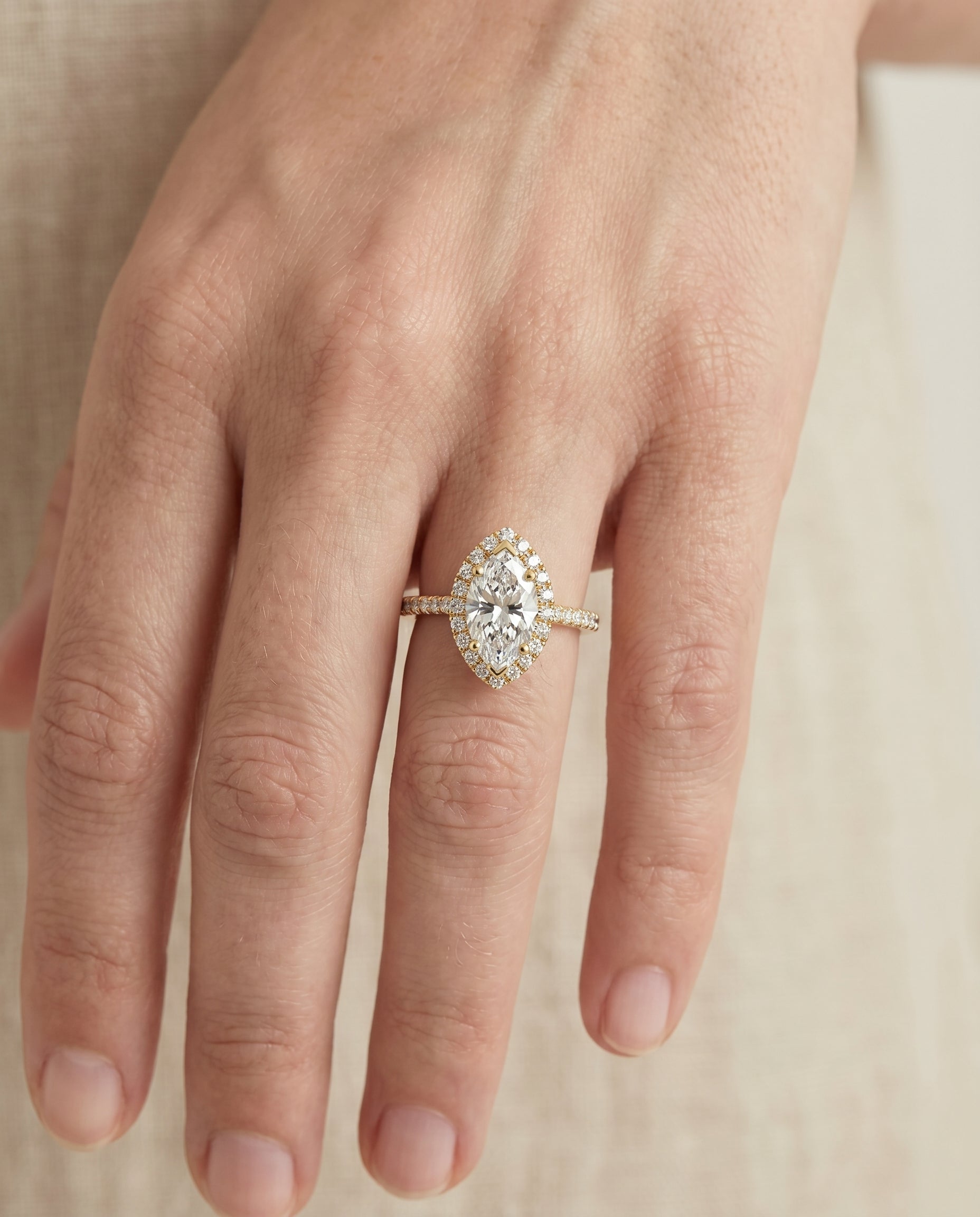 Dylan Select Petite French Pavé Halo Marquise Lab Diamond Engagement Ring in 18K Yellow Gold, shown on hand | RockHer